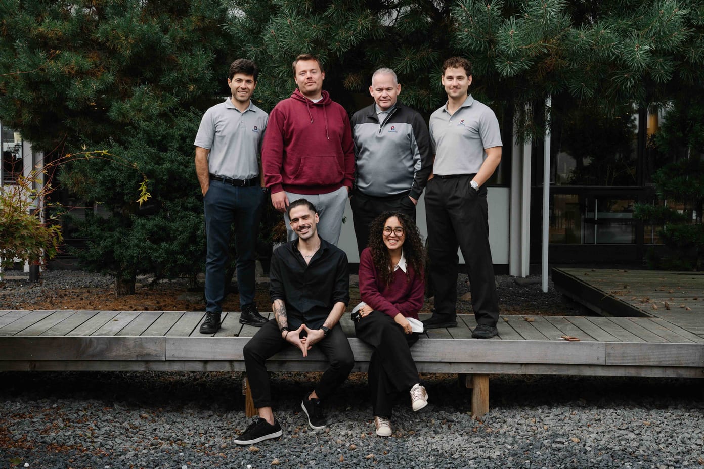 The PB Security team standing together outdoors among the trees at Company Day